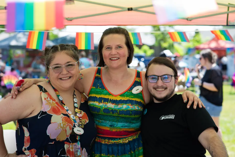 Three Mid-Columbia Libraries staff members pose together at a Pride festival in Pasco.